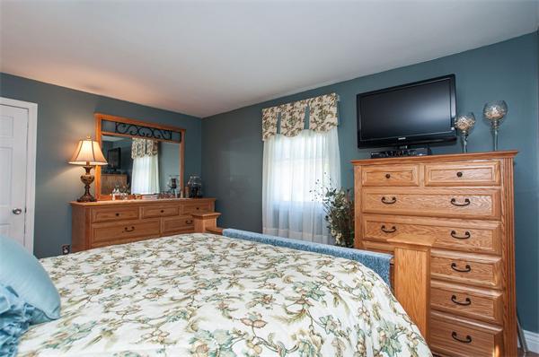 227 West Meadow Road Lowell, MA 01854 - Photo 12 of 25 a bedroom with a bed and a flat screen tv