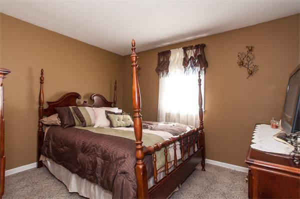 227 West Meadow Road Lowell, MA 01854 - Photo 13 of 25 a bedroom with a bed and wooden floor