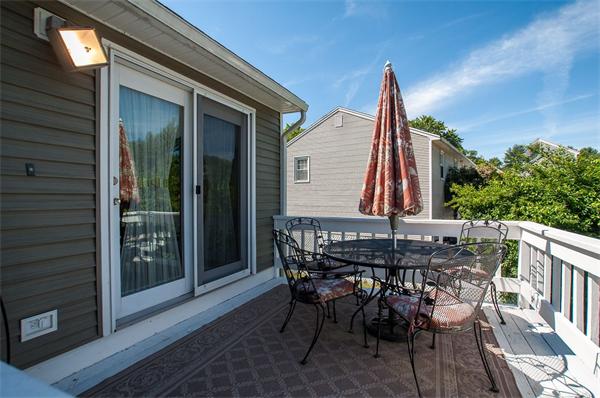227 West Meadow Road Lowell, MA 01854 - Photo 20 of 25 a view of a patio with table and chairs with wooden floor and fence