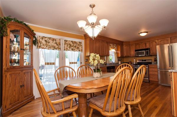 227 West Meadow Road Lowell, MA 01854 - Photo 2 of 25 a dining room with furniture a chandelier and wooden floor