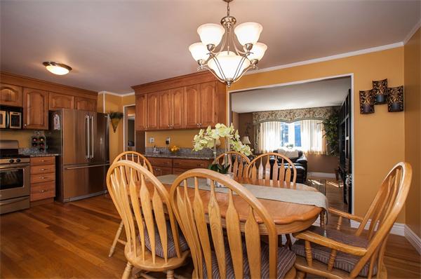 227 West Meadow Road Lowell, MA 01854 - Photo 3 of 25 a view of a dining room with furniture a chandelier and wooden floor