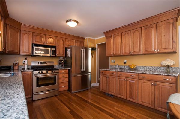227 West Meadow Road Lowell, MA 01854 - Photo 7 of 25 a kitchen with granite countertop wooden cabinets stainless steel appliances and a counter space