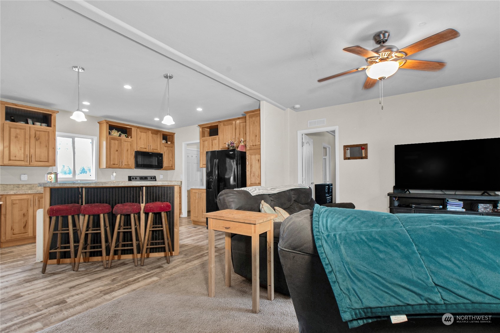 446-67 Meier Road Winlock, WA 98596 - Photo 5 of 33 a living room with furniture a flat screen tv and kitchen view
