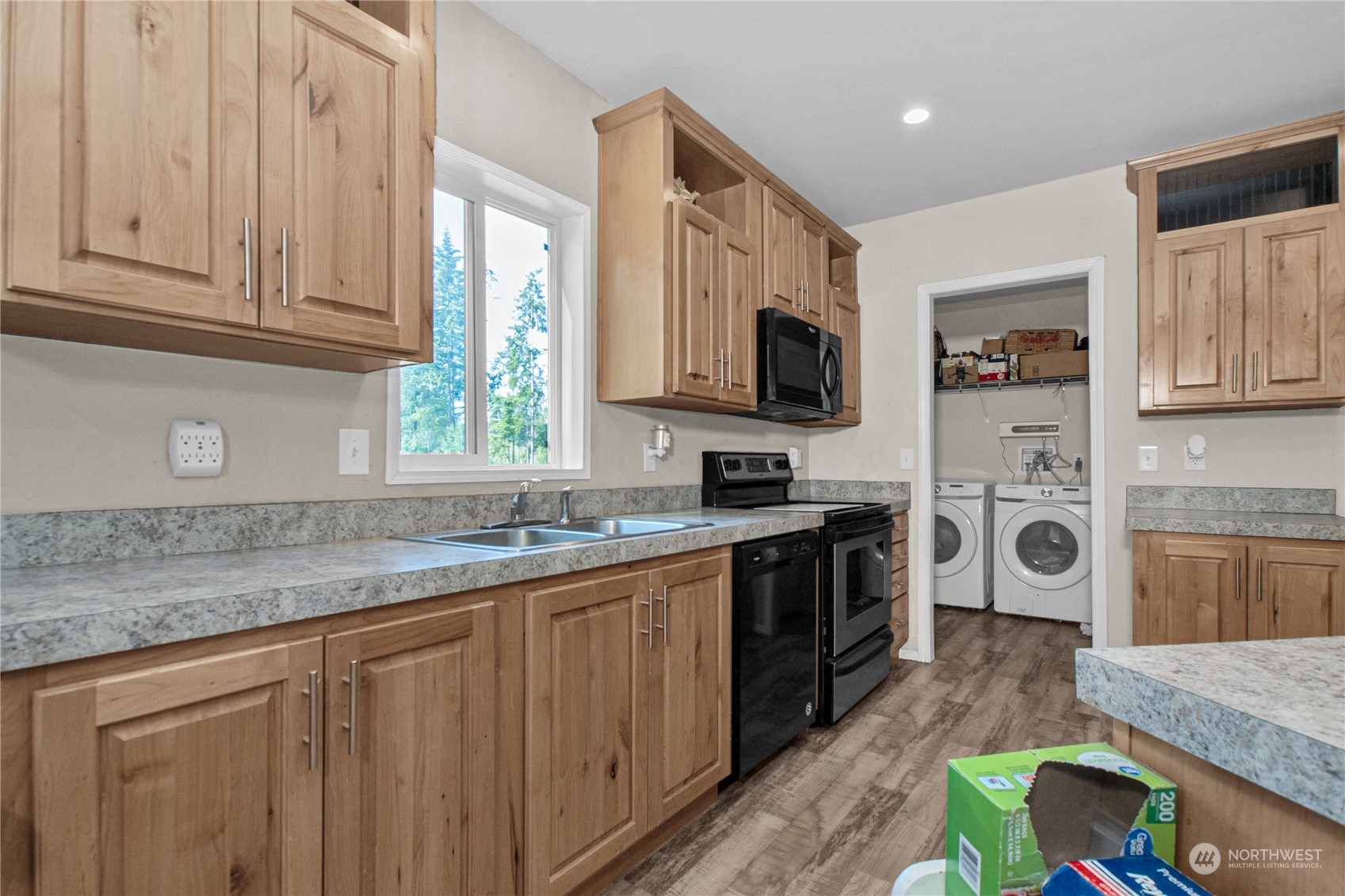 446-67 Meier Road Winlock, WA 98596 - Photo 10 of 33 a kitchen with stainless steel appliances granite countertop a stove a sink and a microwave