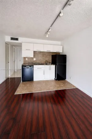 a kitchen with a wooden floor and a sink