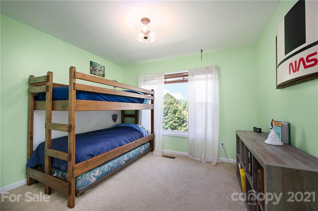 1747 Secluded Valley Road Marshall, NC 28753 - Photo 16 of 33 a bedroom with furniture and a window