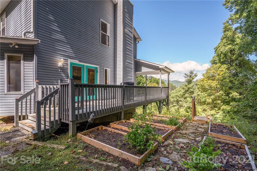 1747 Secluded Valley Road Marshall, NC 28753 - Photo 24 of 33 a view of a chair and table in the backyard