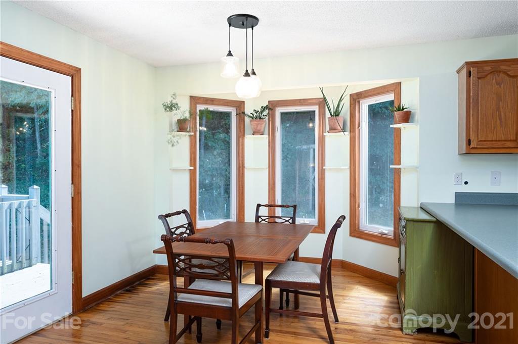 1747 Secluded Valley Road Marshall, NC 28753 - Photo 7 of 33 a dining room with furniture and window