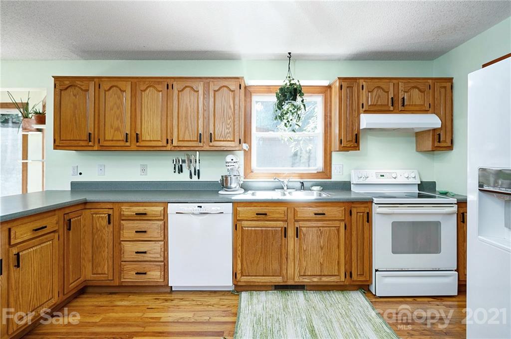 1747 Secluded Valley Road Marshall, NC 28753 - Photo 8 of 33 a kitchen with stainless steel appliances granite countertop a sink stove and cabinets