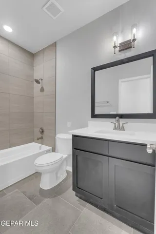 a bathroom with a toilet a sink a mirror and bathtub