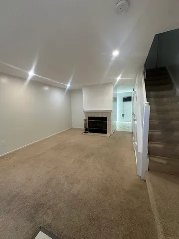 a view of empty room with a fireplace