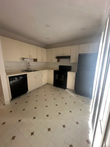 a kitchen with kitchen island sink refrigerator and stove