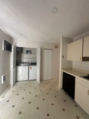 a kitchen with granite countertop a refrigerator and a sink