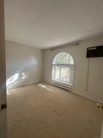 an empty room with a window and a fireplace