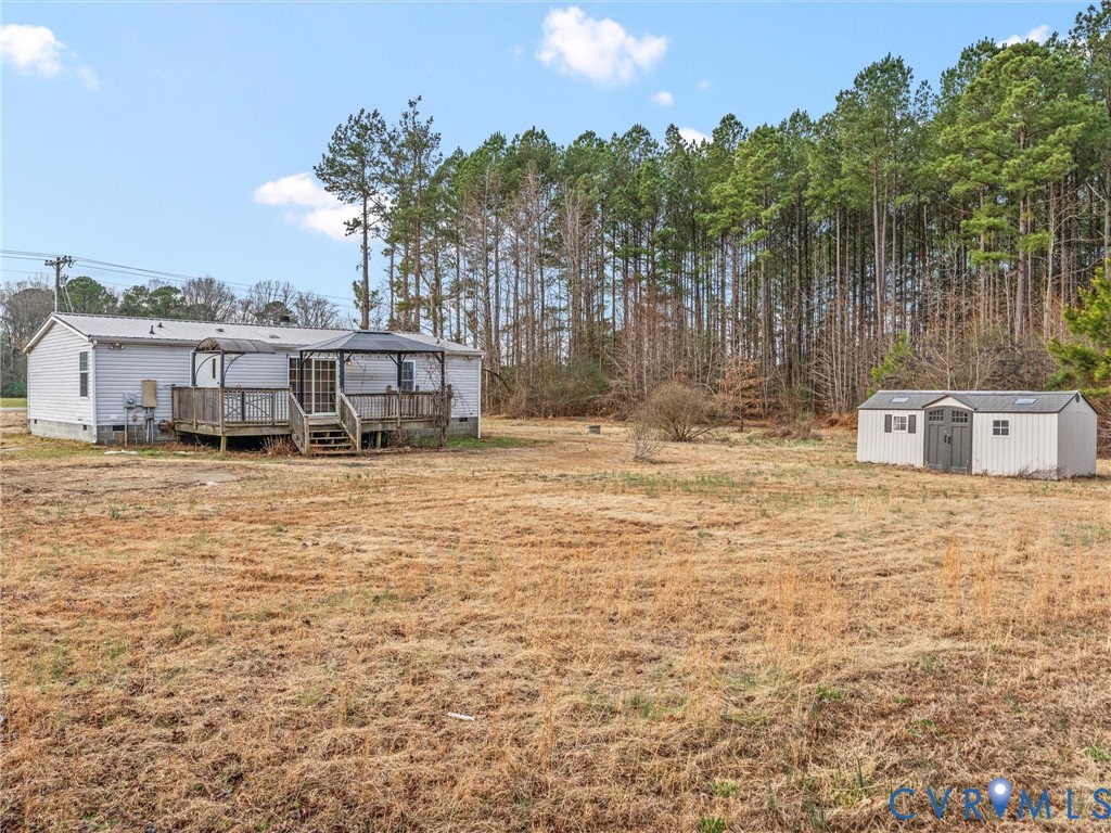 4772 Carsley Road Waverly, VA 23890 - Photo 32 of 38 View of grassy yard featuring a wooden deck and a