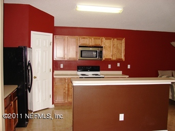 10645 Spring View Road Jacksonville, FL 32221 - Photo 4 of 10 a kitchen with stainless steel appliances a refrigerator sink and stove
