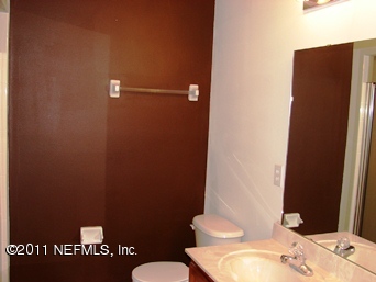 10645 Spring View Road Jacksonville, FL 32221 - Photo 7 of 10 a bathroom with a sink and a mirror