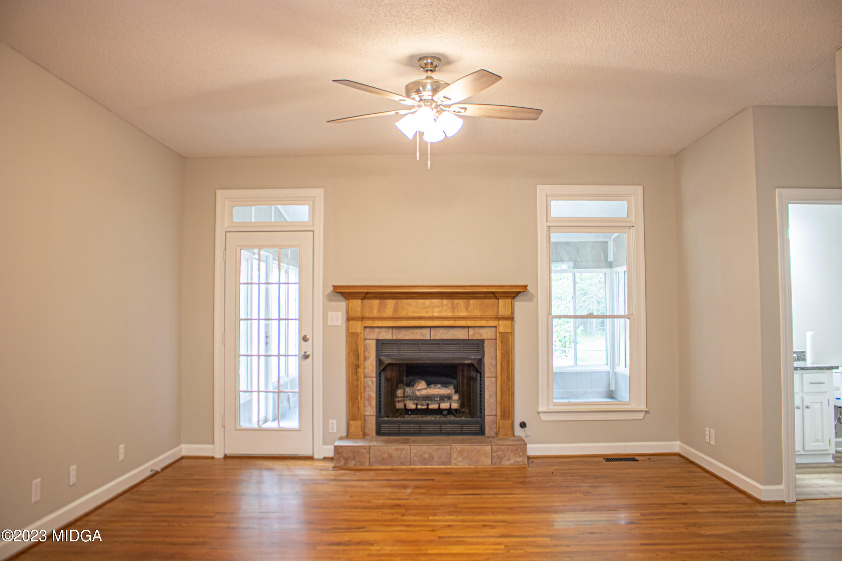 2818 Pea Ridge Road Juliette, GA 31046 - Photo 18 of 71 a view of a livingroom with a fireplace a ceiling fan and windows