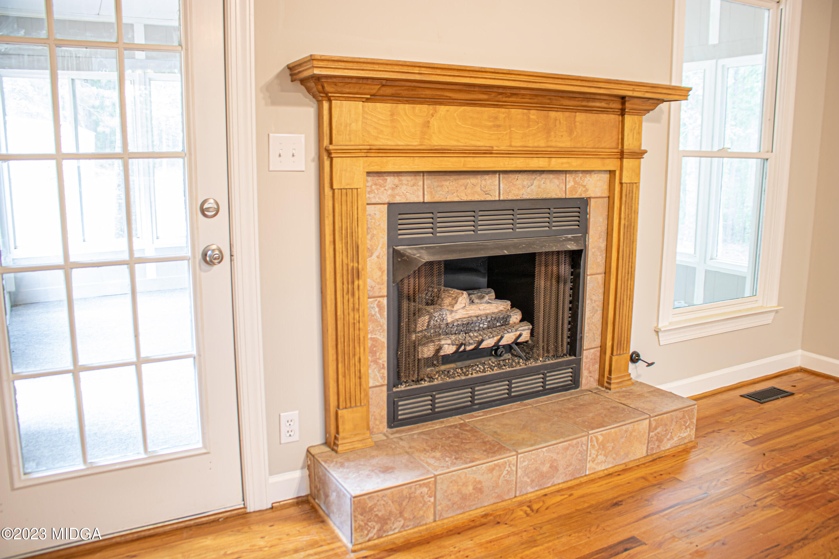 2818 Pea Ridge Road Juliette, GA 31046 - Photo 19 of 71 a living room with a fireplace with wooden floor
