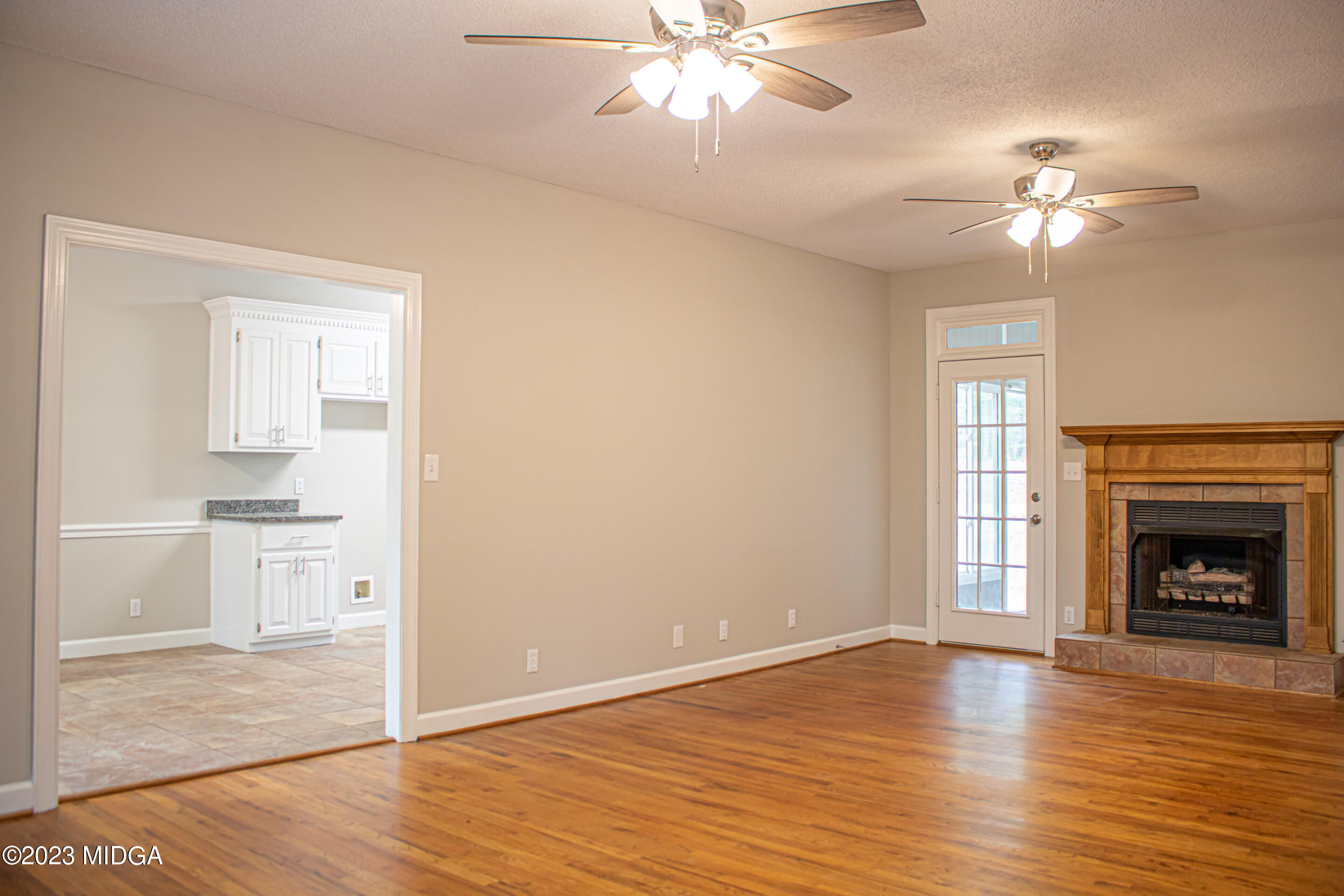 2818 Pea Ridge Road Juliette, GA 31046 - Photo 20 of 71 a view of a livingroom with a fireplace wooden floor and a chandelier fan