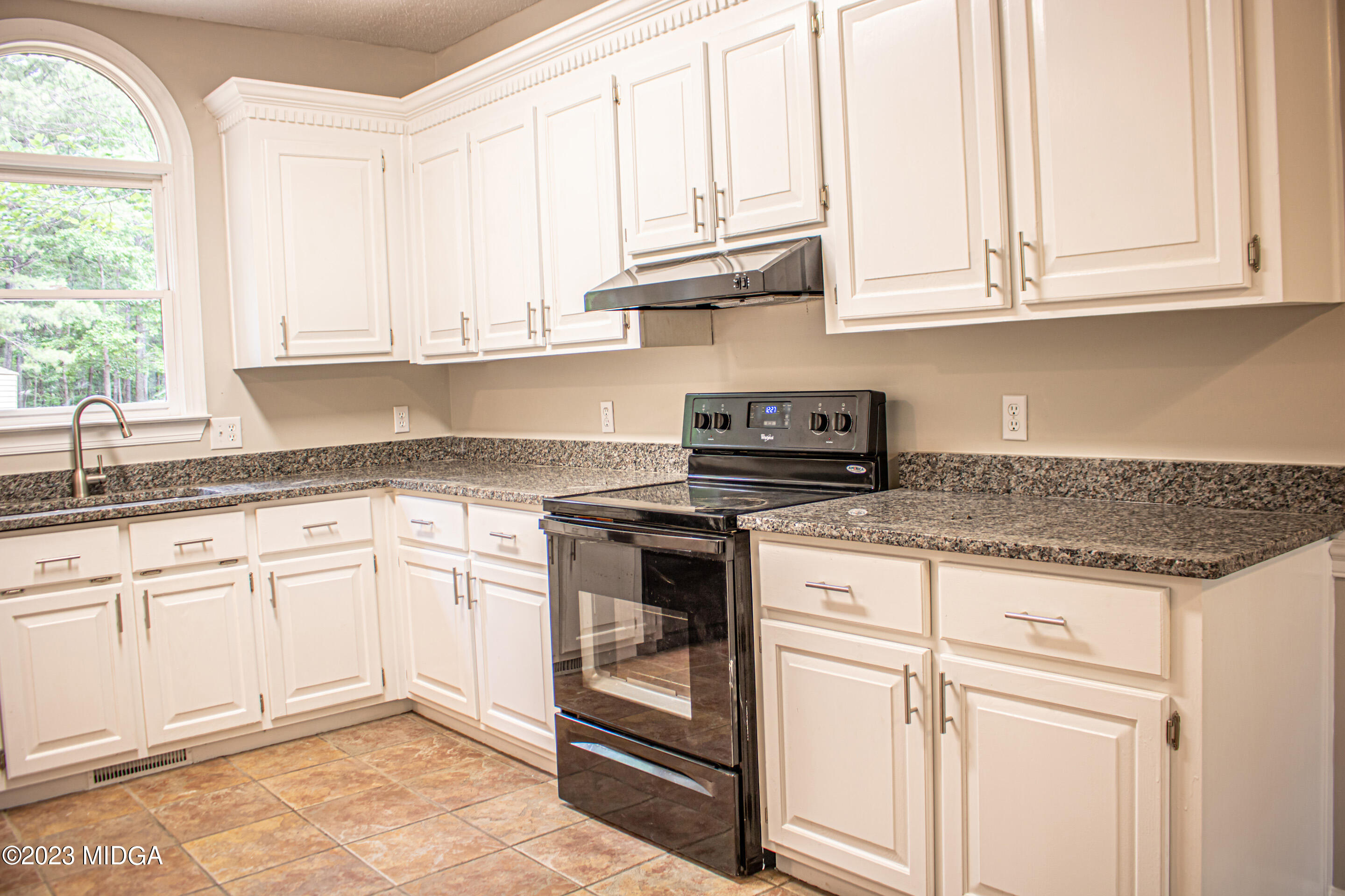2818 Pea Ridge Road Juliette, GA 31046 - Photo 23 of 71 a kitchen with granite countertop white cabinets and a stainless steel appliances