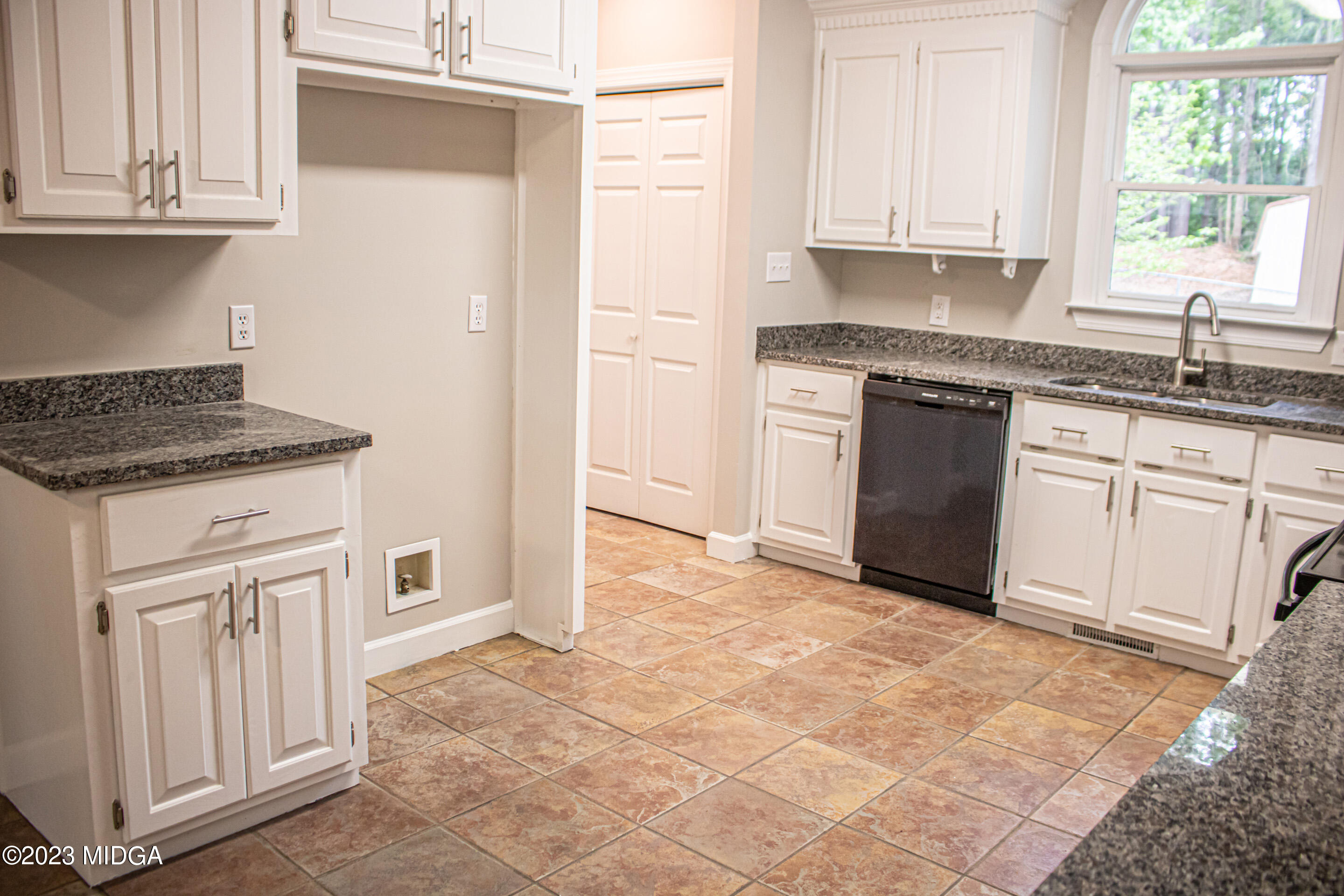 2818 Pea Ridge Road Juliette, GA 31046 - Photo 27 of 71 a kitchen with granite countertop a sink stove and cabinets
