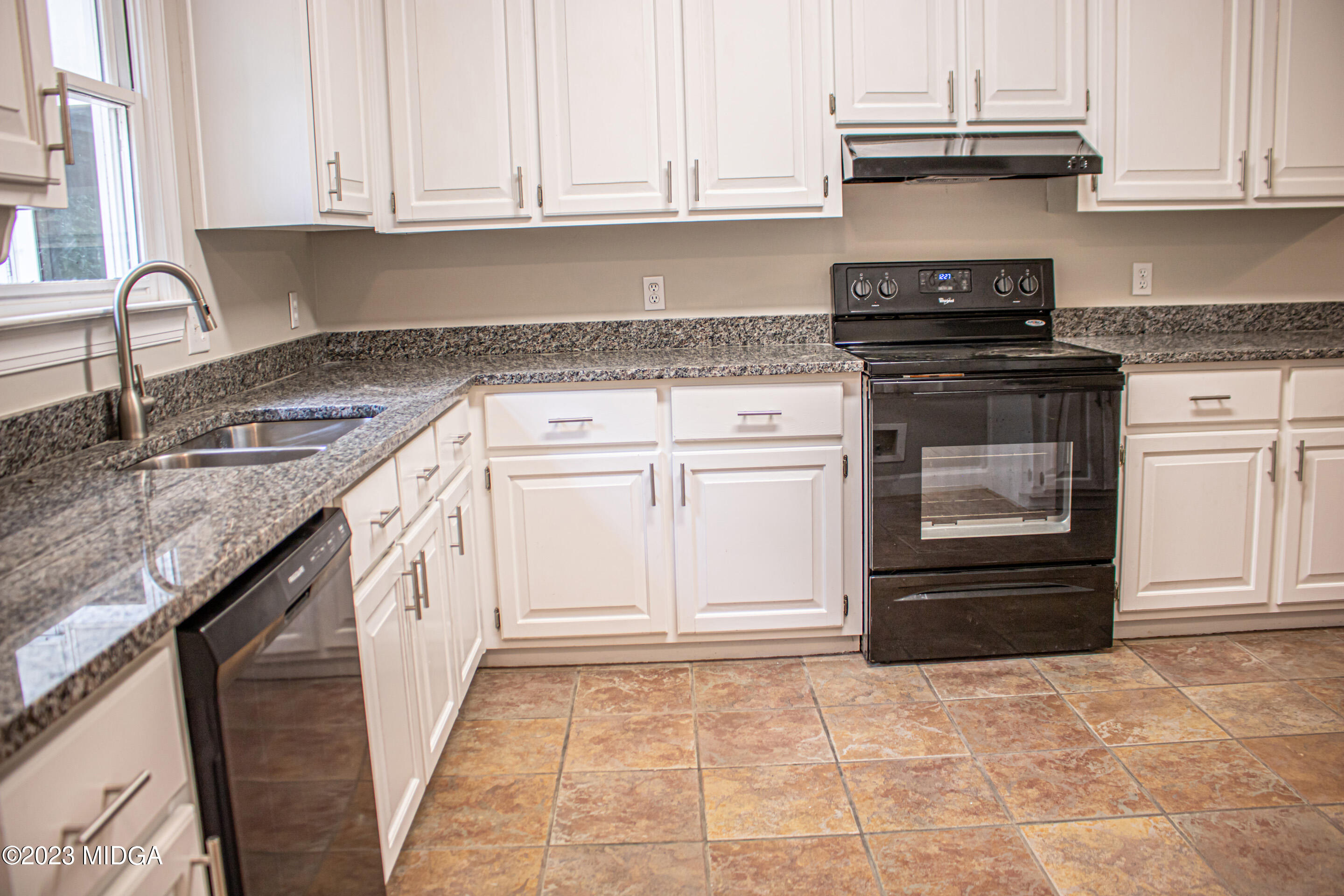 2818 Pea Ridge Road Juliette, GA 31046 - Photo 28 of 71 a kitchen with granite countertop a stove sink and cabinets