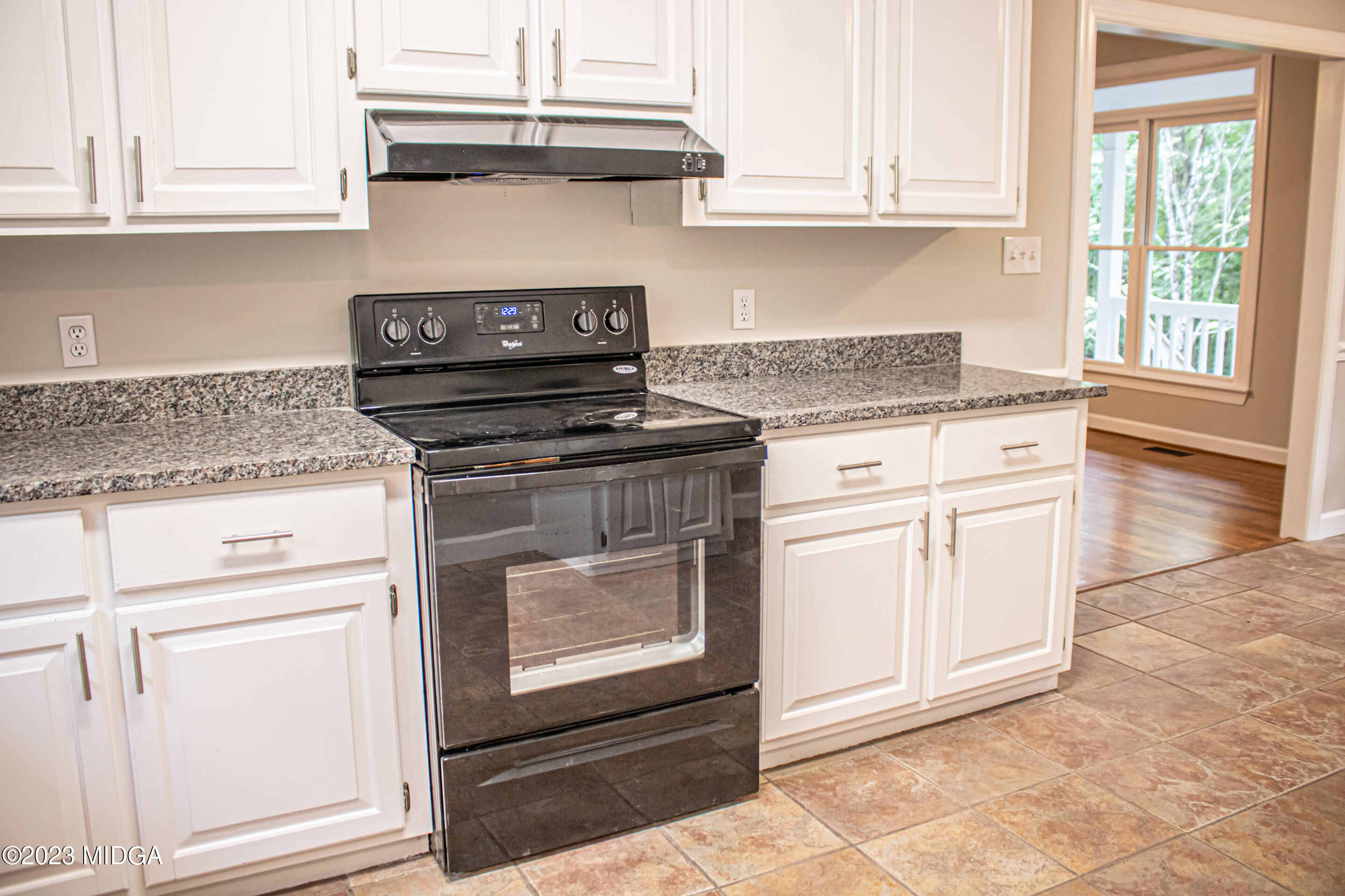 2818 Pea Ridge Road Juliette, GA 31046 - Photo 29 of 71 a kitchen with granite countertop white cabinets and white appliances