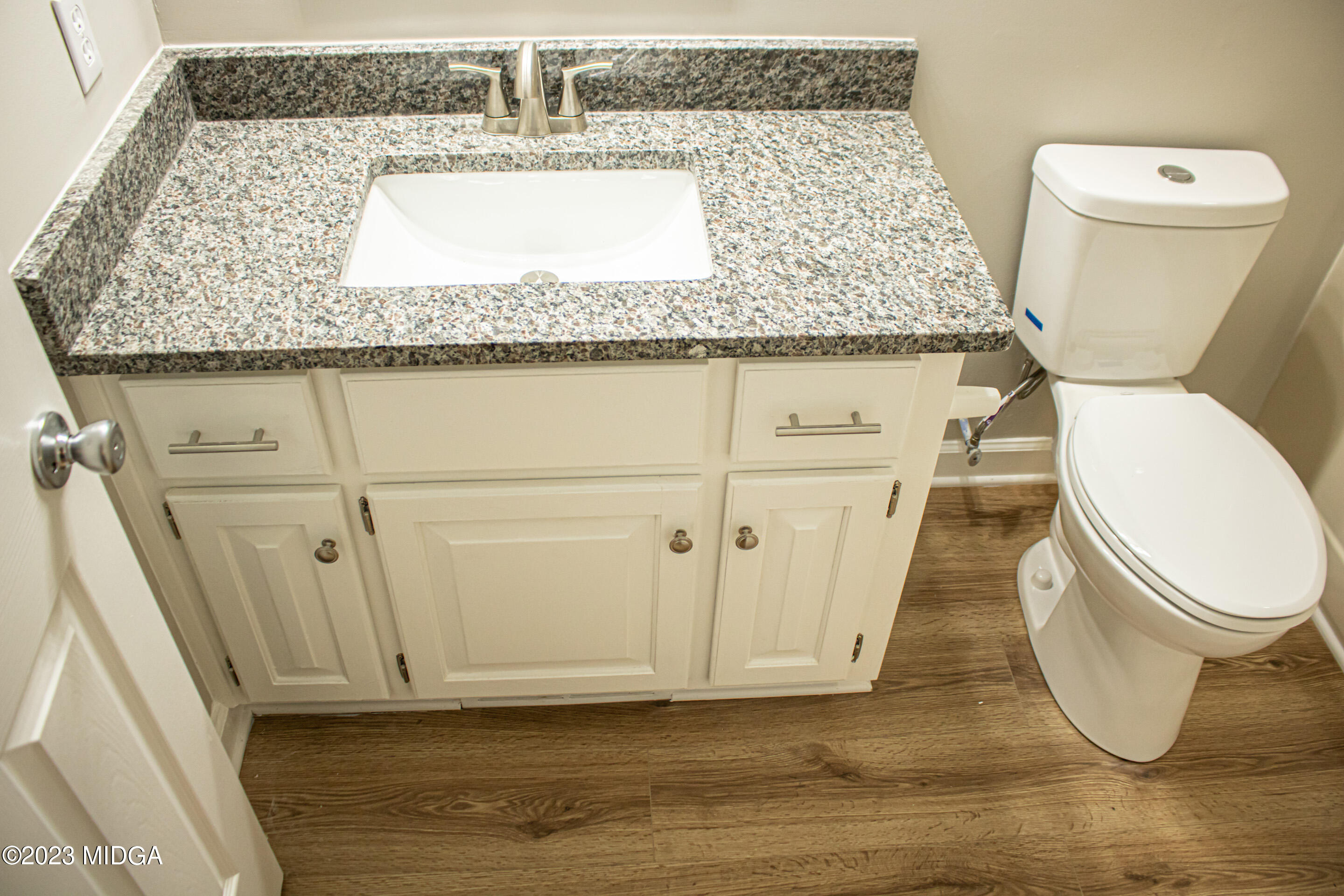 2818 Pea Ridge Road Juliette, GA 31046 - Photo 36 of 71 a bathroom with a granite countertop toilet and a sink
