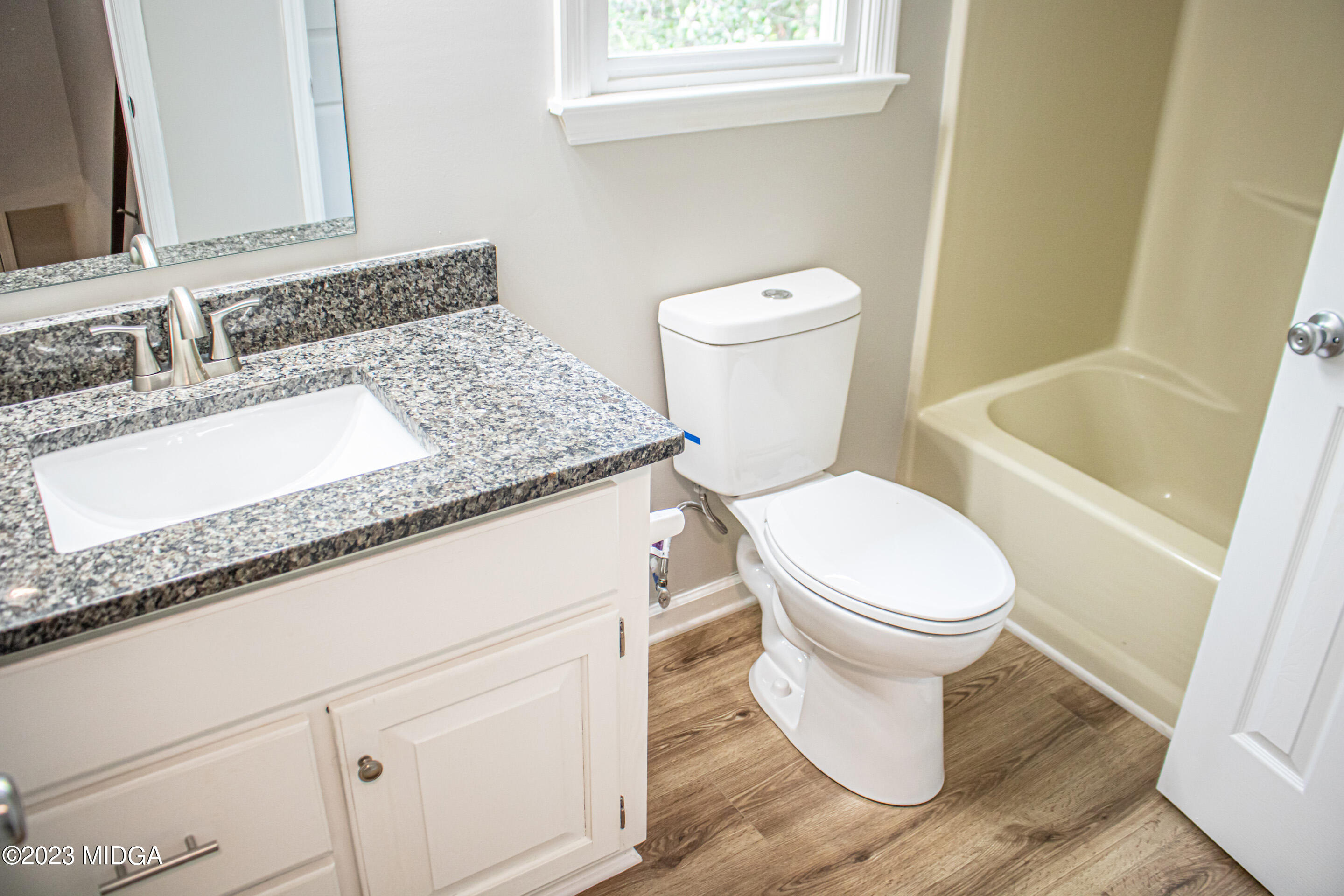 2818 Pea Ridge Road Juliette, GA 31046 - Photo 40 of 71 a bathroom with a granite countertop toilet and a sink