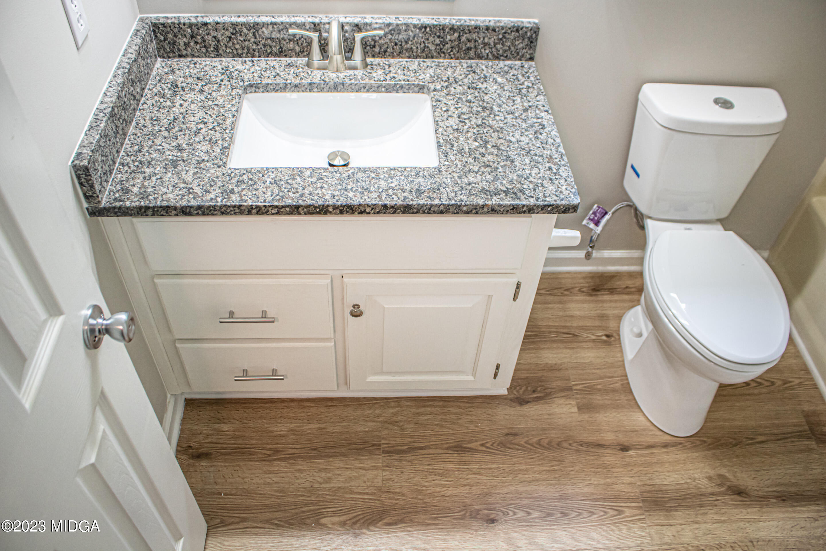 2818 Pea Ridge Road Juliette, GA 31046 - Photo 41 of 71 a bathroom with a granite countertop toilet and a sink