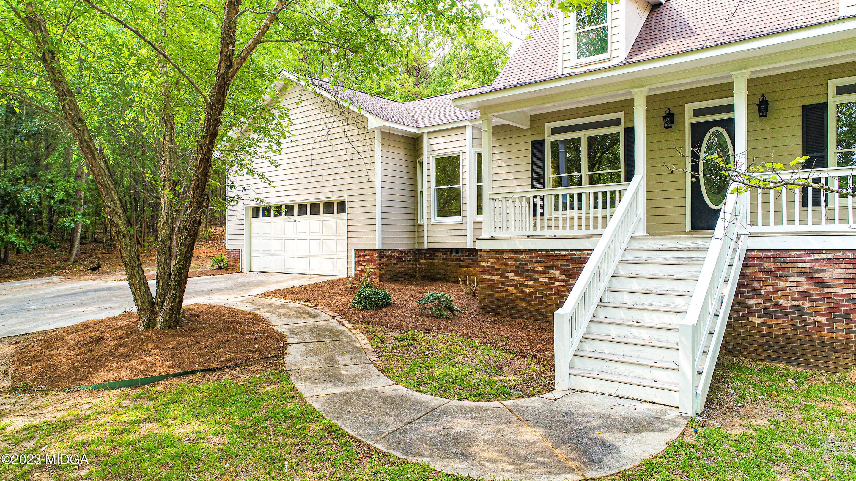 2818 Pea Ridge Road Juliette, GA 31046 - Photo 7 of 71 a view of a house with a backyard and a tree