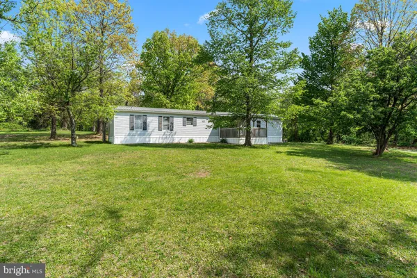 a view of house with backyard