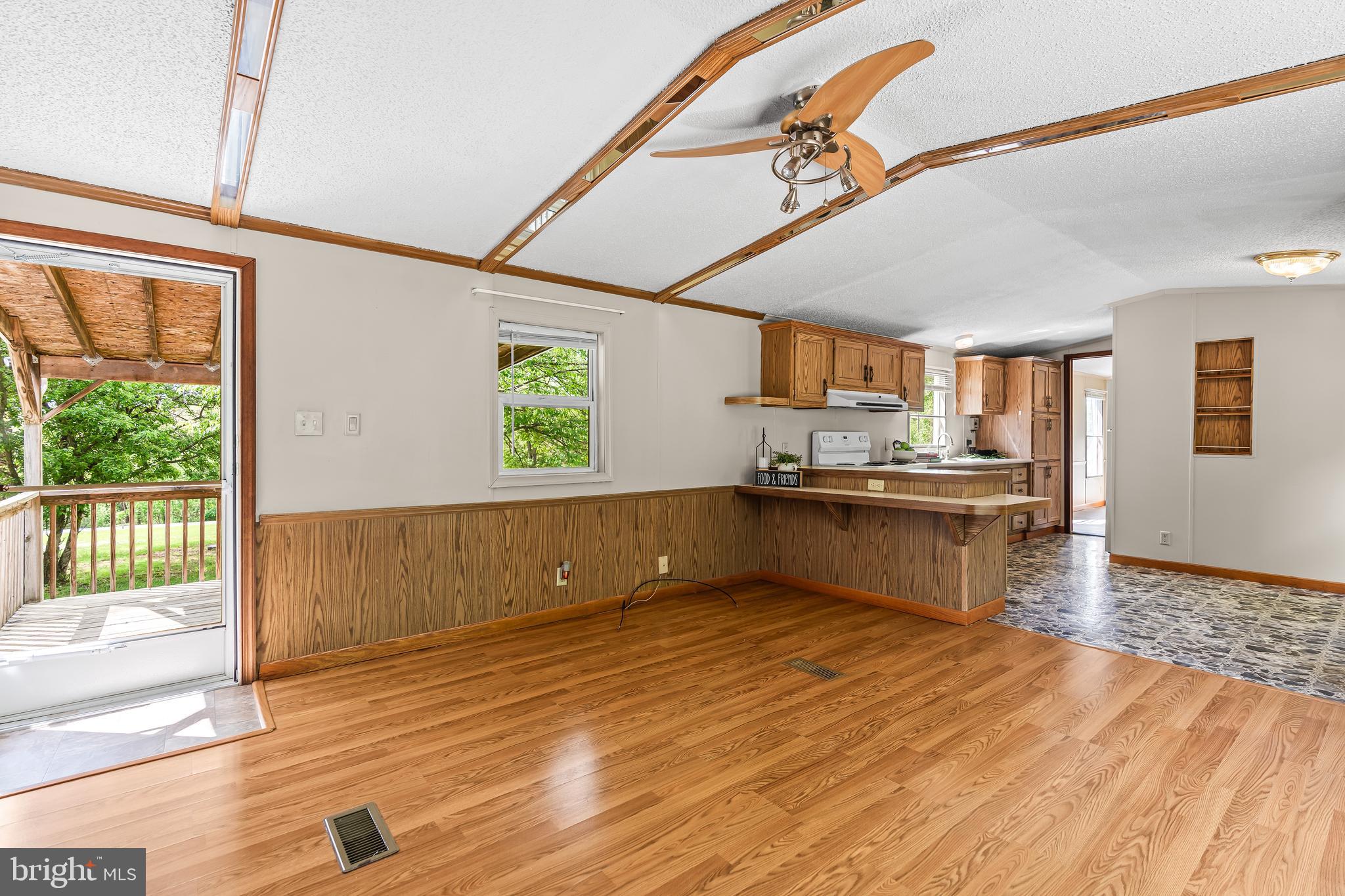 1217 Nestle Quarry Road Falling Waters, WV 25419 - Photo 18 of 52 a kitchen with stainless steel appliances granite countertop a sink window and wooden floor