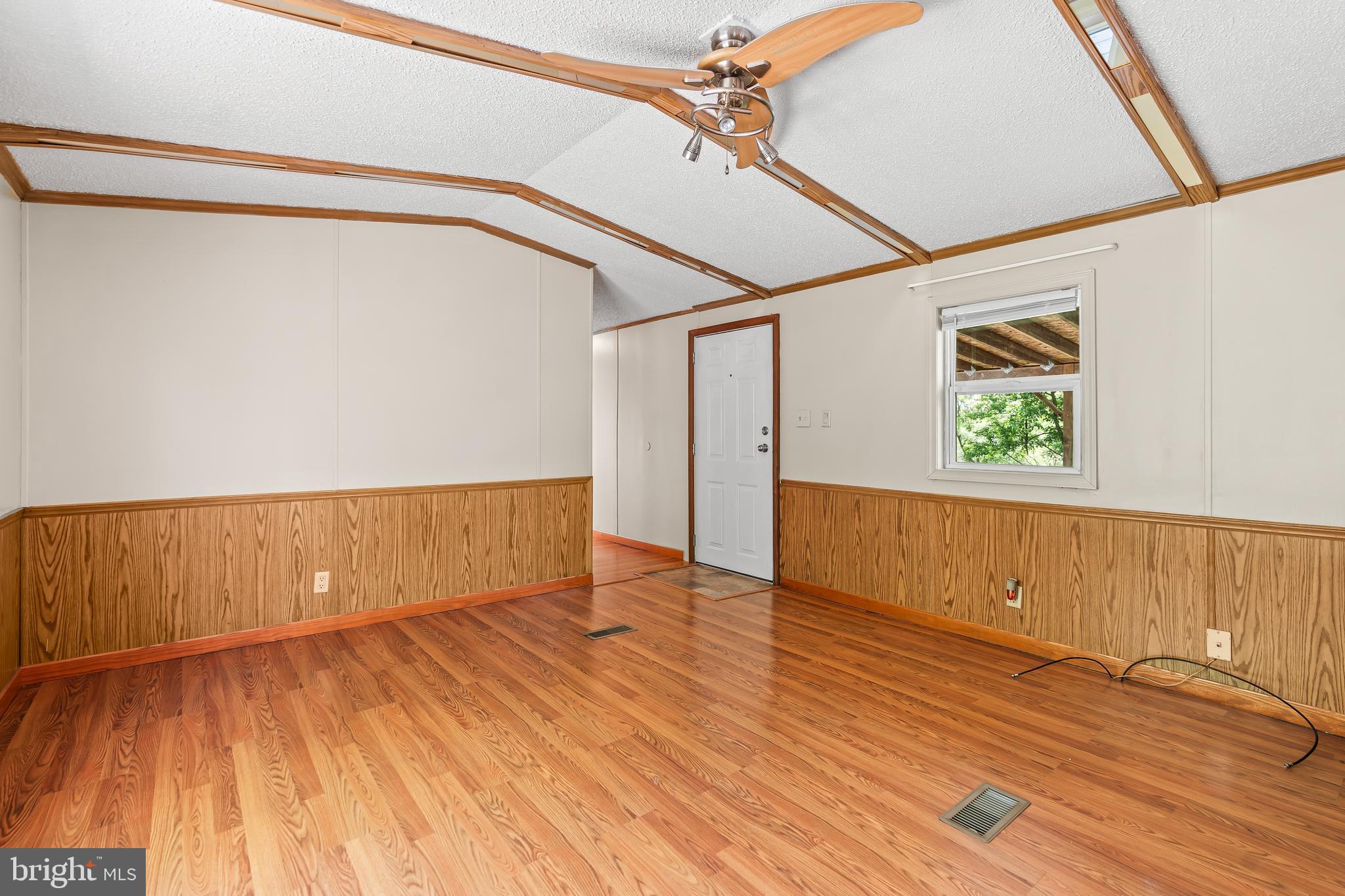 1217 Nestle Quarry Road Falling Waters, WV 25419 - Photo 19 of 52 a view of an empty room with wooden floor and a window