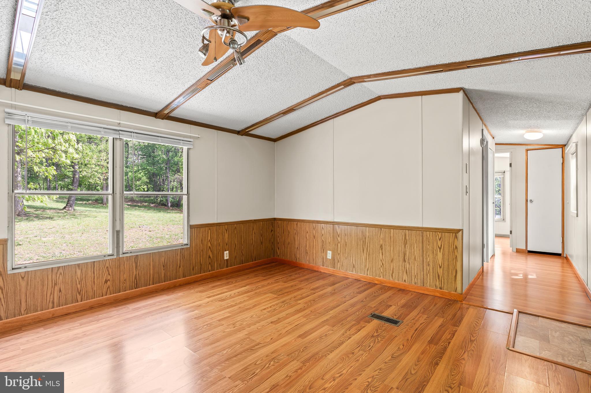 1217 Nestle Quarry Road Falling Waters, WV 25419 - Photo 20 of 52 a view of an empty room with wooden floor and a window