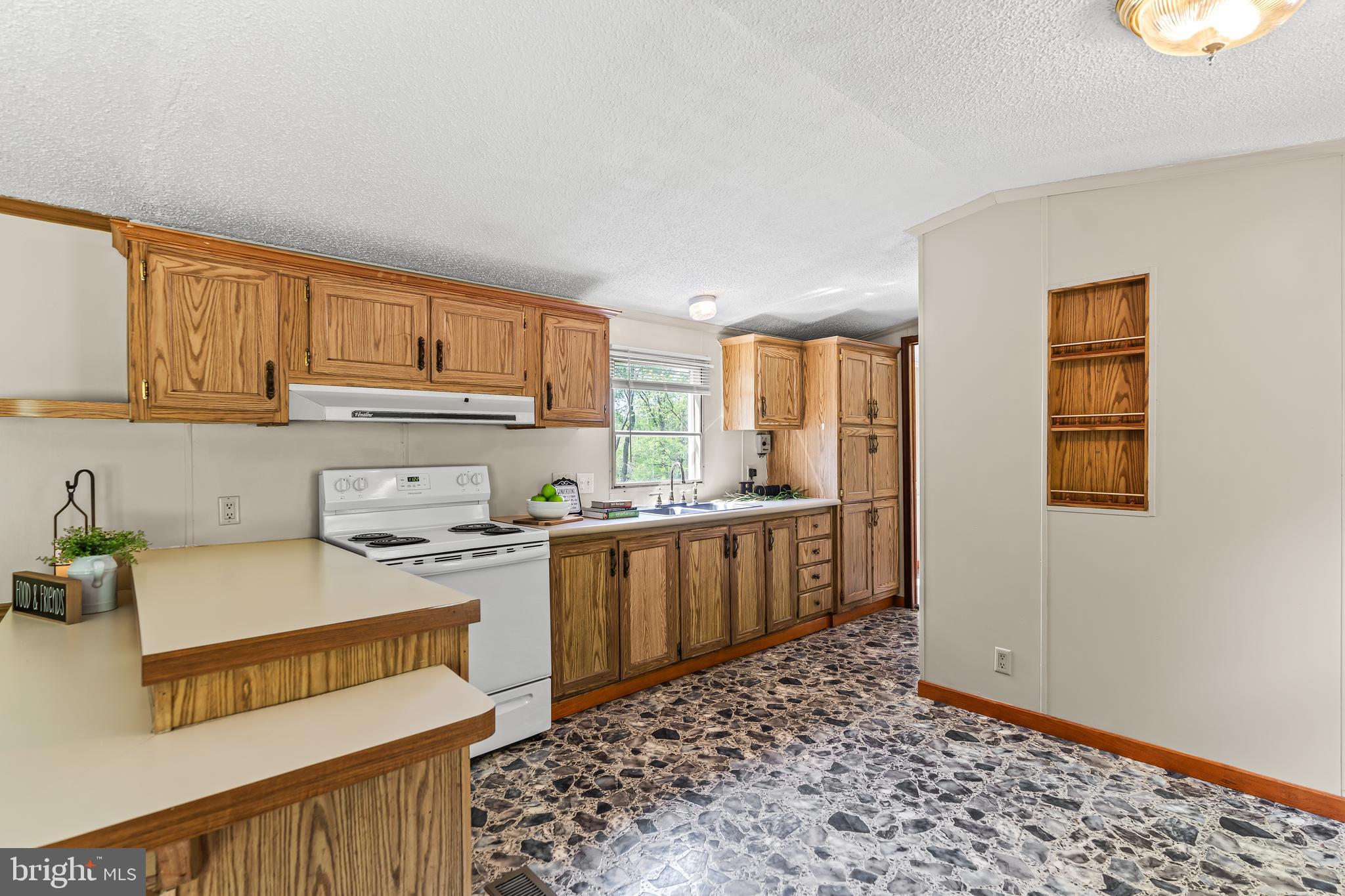 1217 Nestle Quarry Road Falling Waters, WV 25419 - Photo 22 of 52 a kitchen with a refrigerator and a stove top oven
