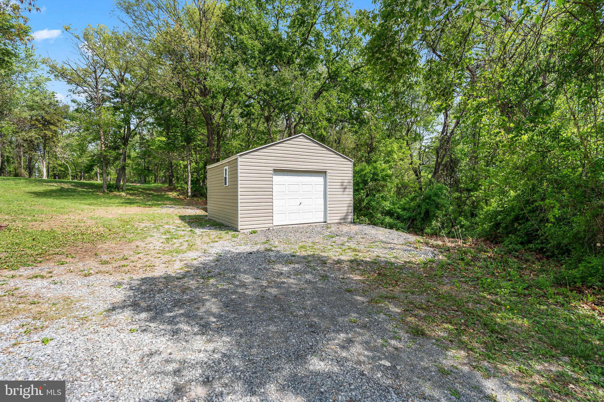1217 Nestle Quarry Road Falling Waters, WV 25419 - Photo 8 of 52 a front view of a house with a yard and garage
