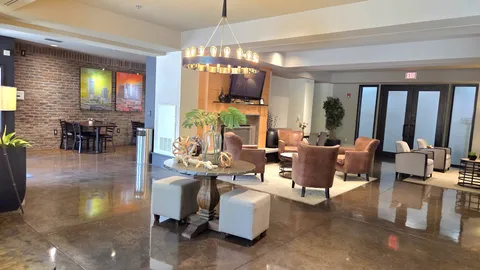 a living room with fireplace furniture and a chandelier