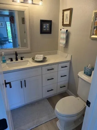 a bathroom with a toilet a sink and mirror