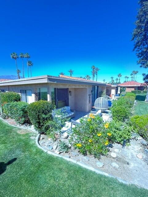 41 Sunrise Drive Rancho Mirage, CA 92270 - Photo 21 of 51 a view of a small yard in front of a house with a large tree