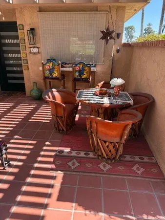 a view of a patio with table and chairs