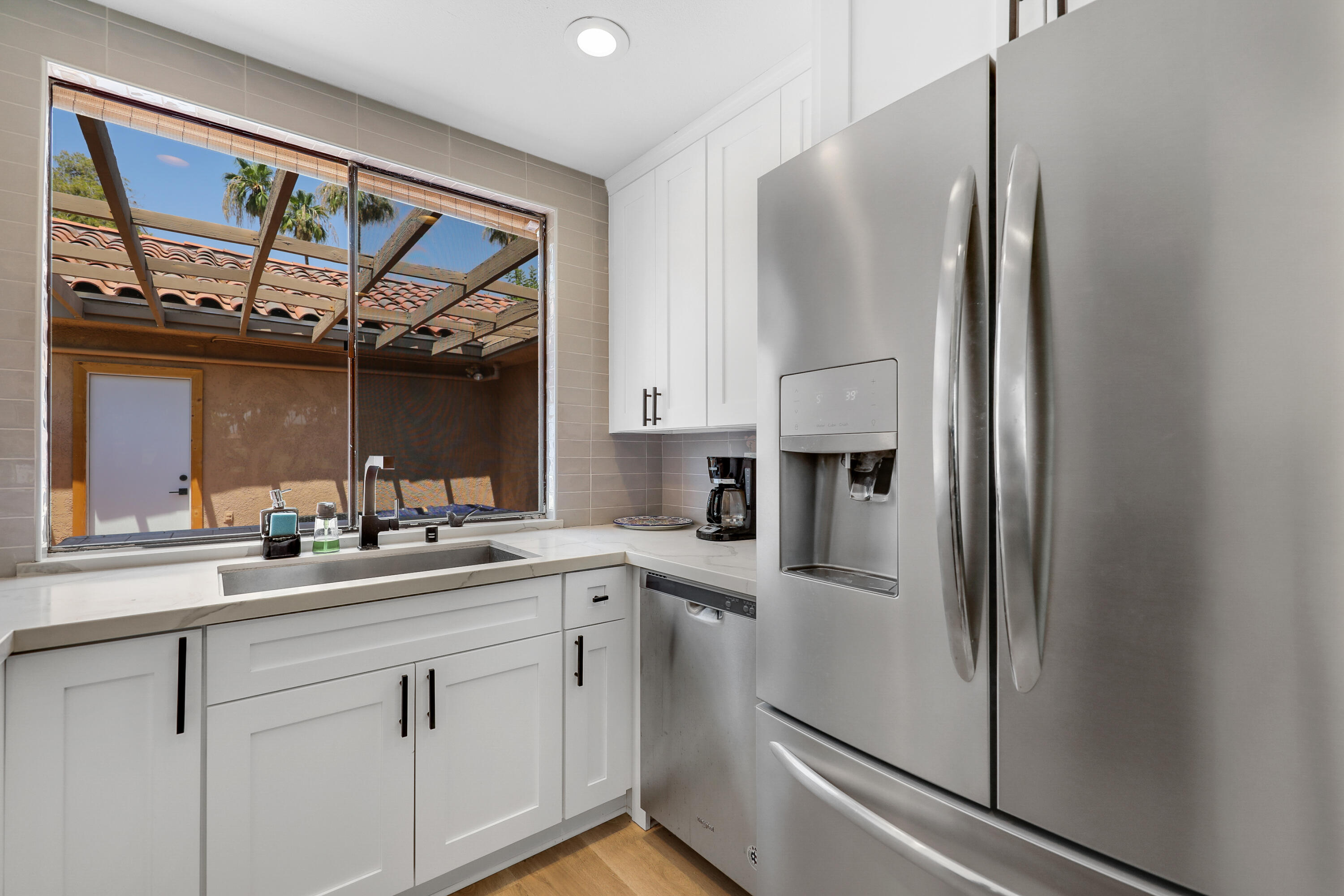 41 Sunrise Drive Rancho Mirage, CA 92270 - Photo 6 of 51 a kitchen with stainless steel appliances a sink and a refrigerator