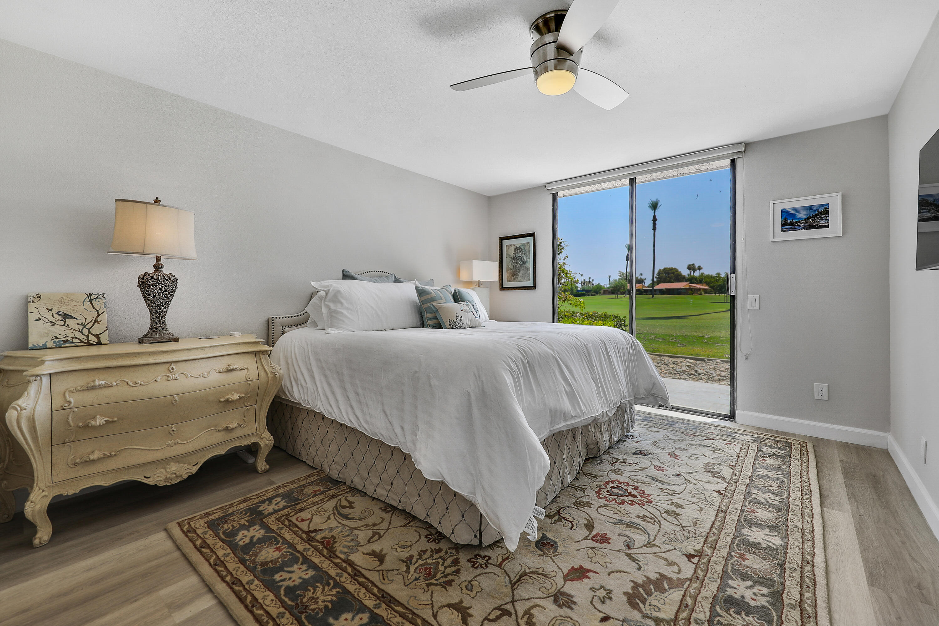 41 Sunrise Drive Rancho Mirage, CA 92270 - Photo 8 of 51 a bedroom with a bed and a lamp on dresser