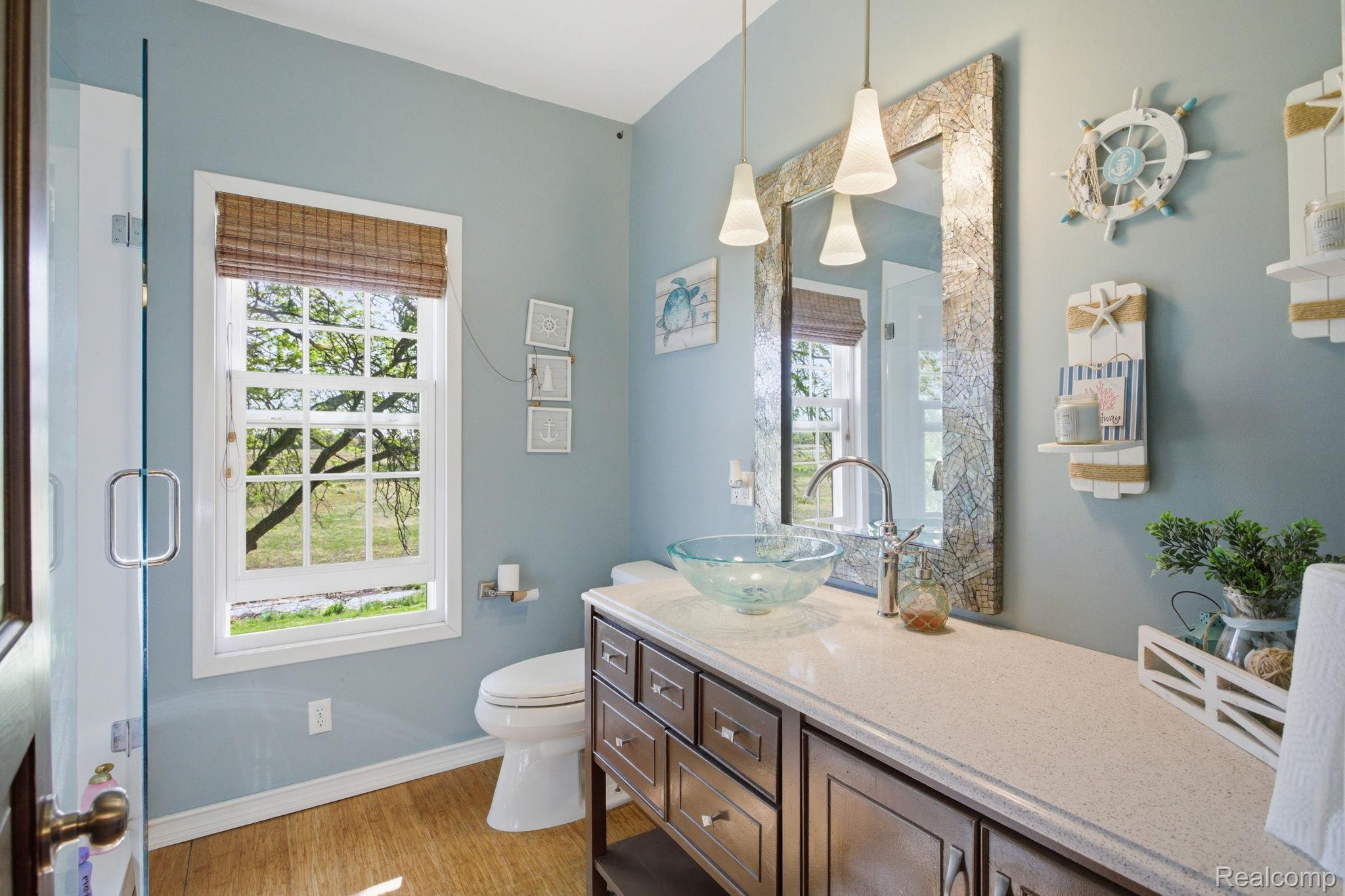 14104 Carleton West Road Carleton, MI 48117 - Photo 35 of 58 Bathroom with vanity, healthy amount of natural light, light wood-style flooring, and an enclosed shower