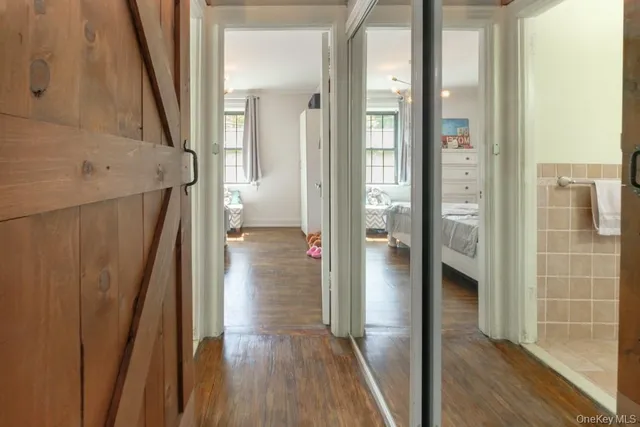 a view of a hallway with wooden floor and staircase