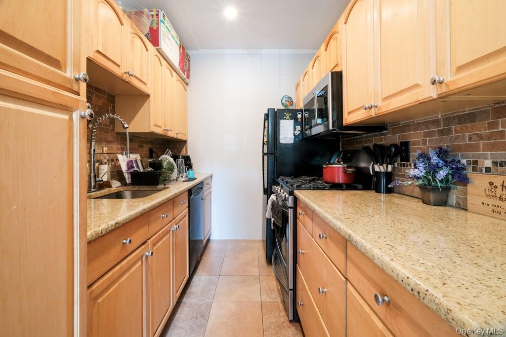 23 Old Mamaroneck Road, Unit 1M White Plains, NY 10605 - Photo 7 of 19 a kitchen with storage and utility