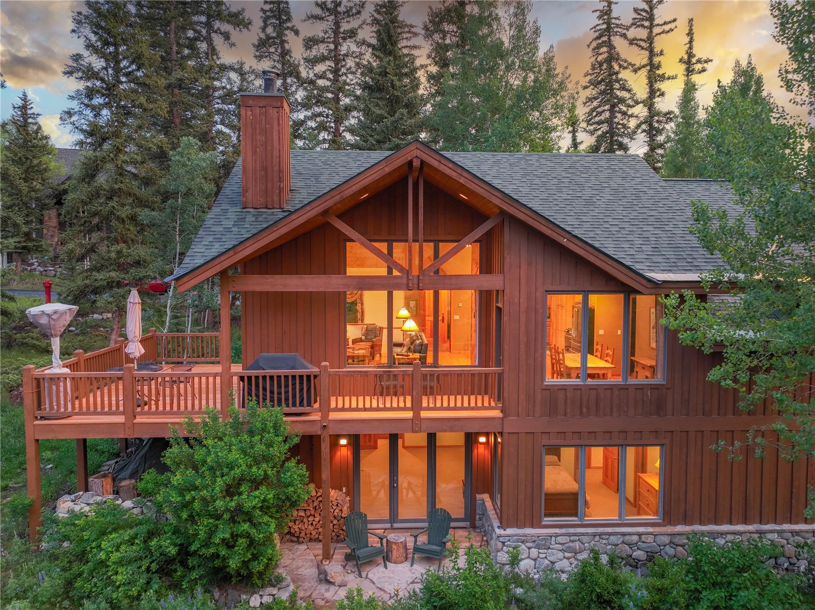 760 Penstemon Road Keystone, CO 80435 - Photo 38 of 39 Back house at dusk with a patio and a wooden deck