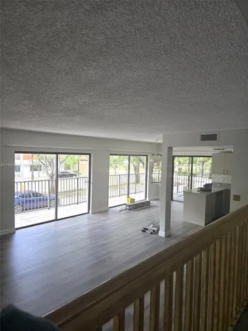 a view of a room with wooden floor and stairs