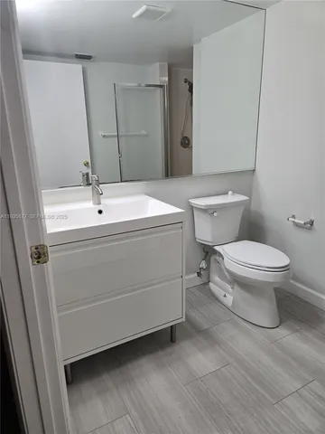 a bathroom with a sink a toilet and vanity